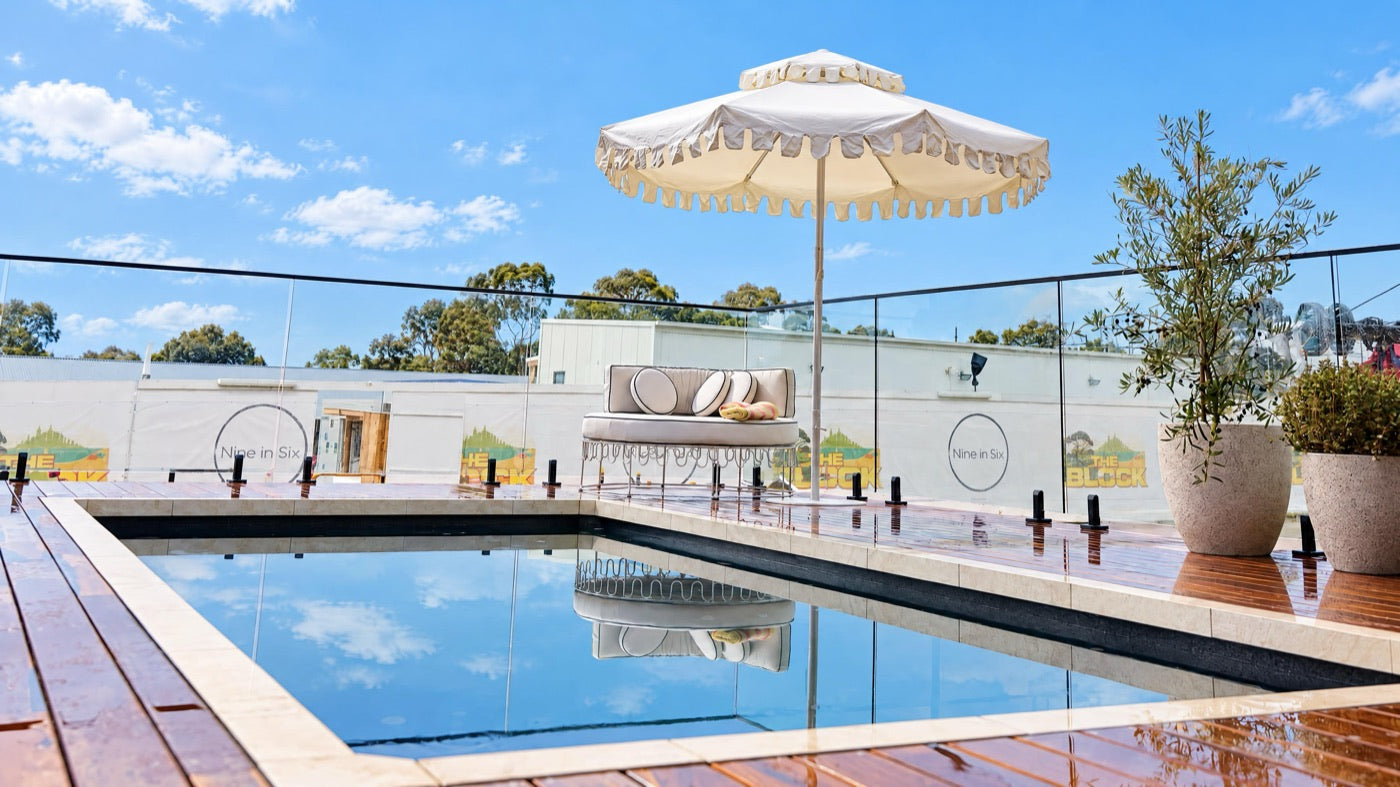 Ivory Mist umbrella by Retro Umbrella Co at Lisa & Rosco's pool on The Block 2026