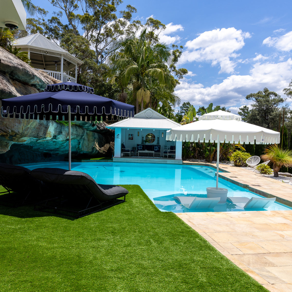 Retro Umbrella Co double-tier umbrellas beside a pool