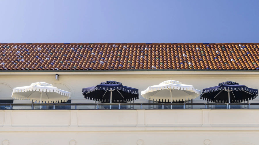 Retro Umbrella Co double-tier umbrella shading a pool terrace